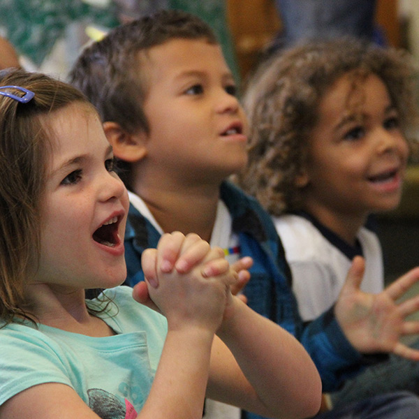 photo of adorable children listening to story time at the public library