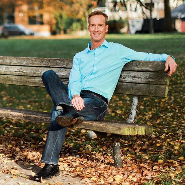 photo of Dr. Ramaley sitting on a park bench in Seattle